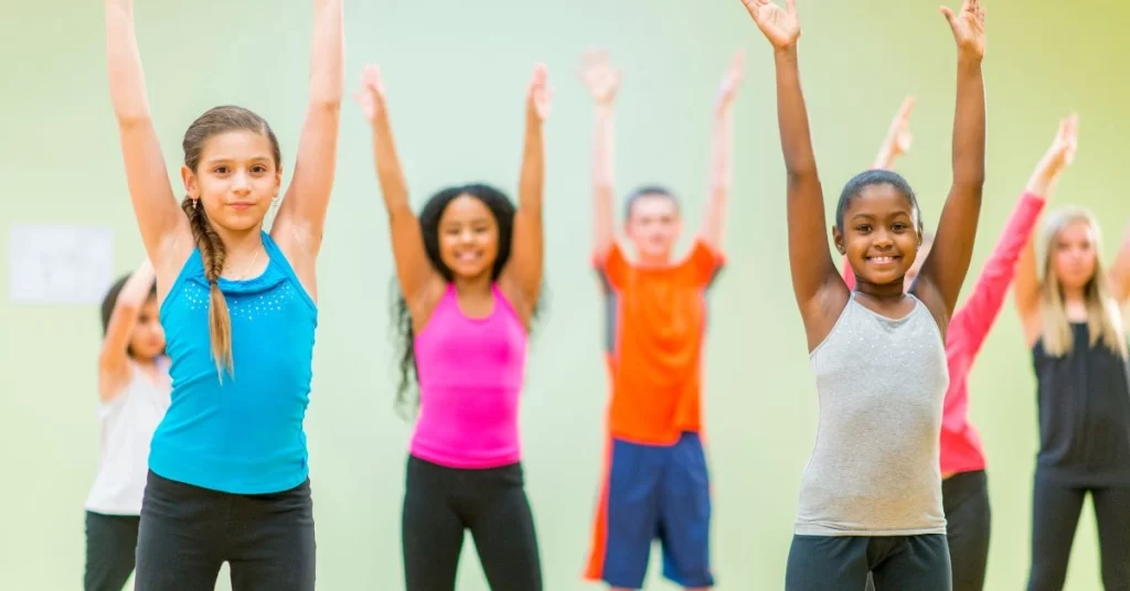 Kids participating in a group fitness activity that builds confidence and teamwork