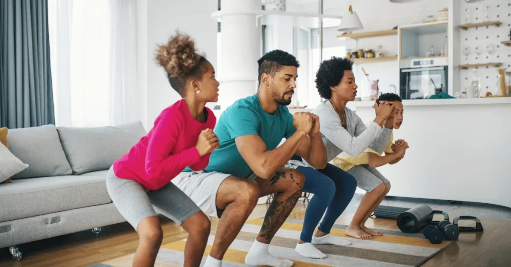 Family exercising together in their living room during an at-home fitness workout