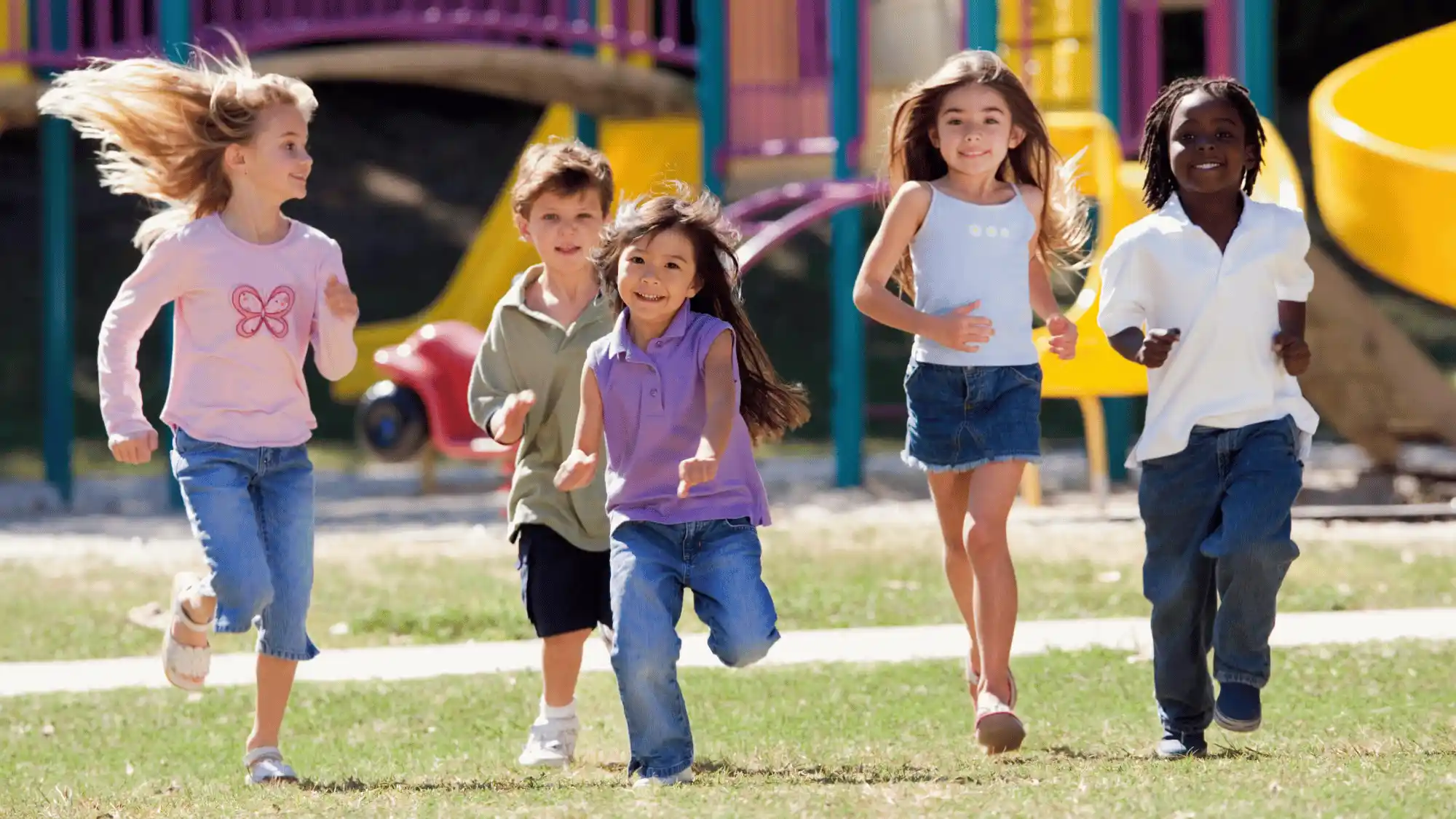 Children running and playing together outdoors as part of healthy daily physical activity.